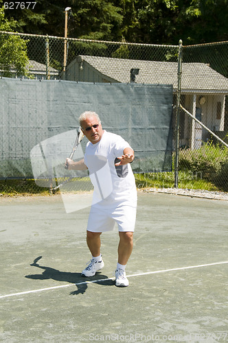 Image of middle age tennis player forehand on court