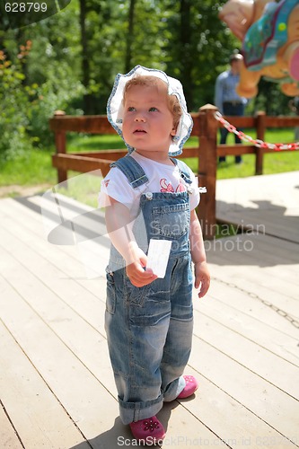 Image of small girl with ticket in hand