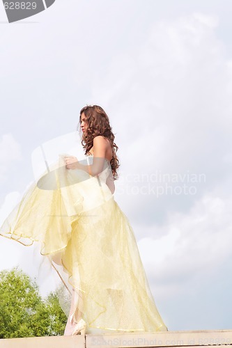 Image of beautiful girl in golden dress