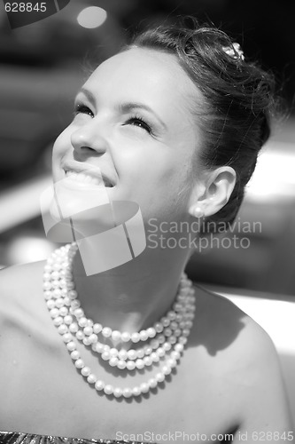 Image of smiling girl with pearl necklace, monochrome