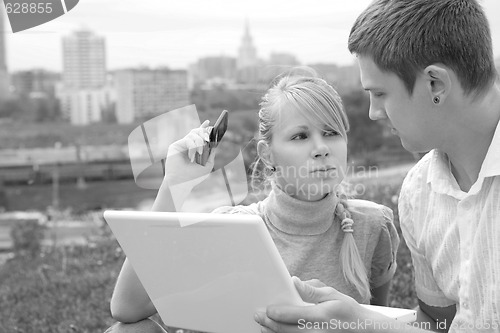 Image of man with white laptop and girl