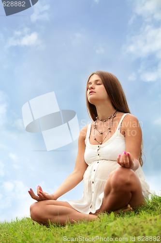Image of pregnant woman is meditating