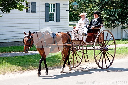 Image of Colonial horse carriage with couple