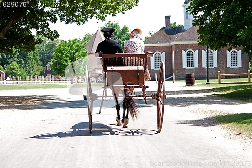 Image of Colonial horse carriage with couple