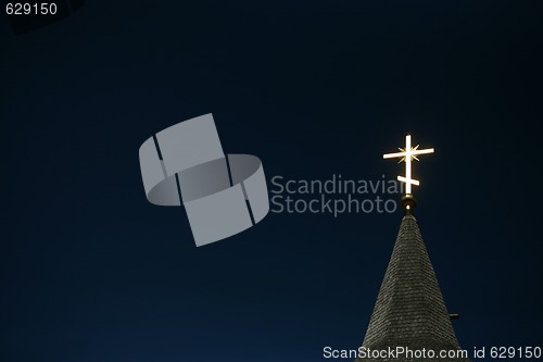 Image of Lighting orthodox cross on a blue sky 