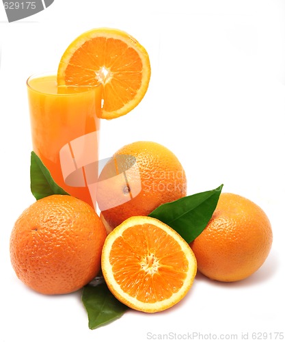 Image of Oranges with green leaves and glass of juice on a white backgrou