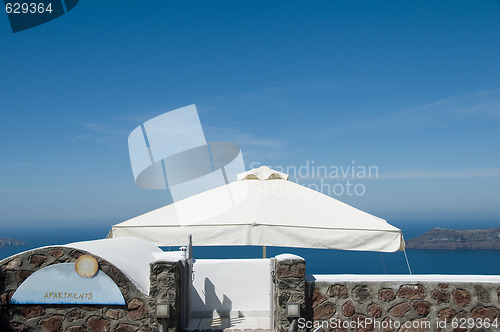 Image of stone tile patio with volcanic island view on santorini