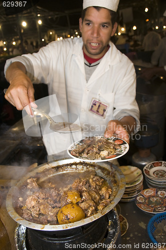 Image of lamb tagine at outdoor restaurant in jemaa el fna plaza square i