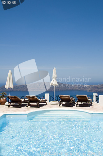 Image of swimming pool view of volcanic island imerovigli santorini greec