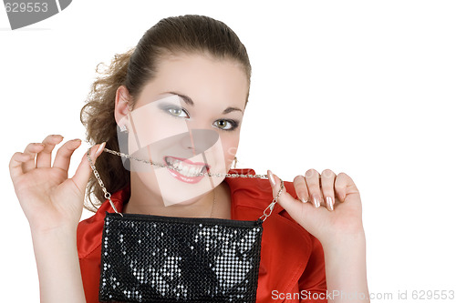 Image of Young beautiful woman with a handbag in a teeth