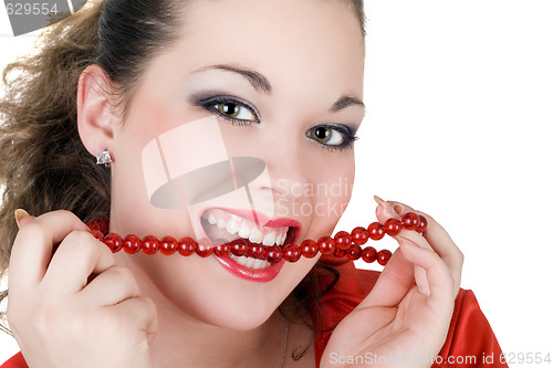 Image of Beautiful young woman with a beads in a teeth