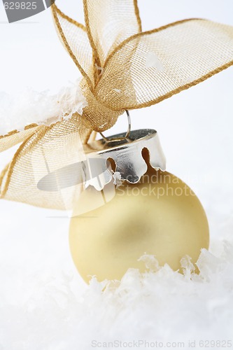 Image of Gold Christmas bauble decoration with ribbon.