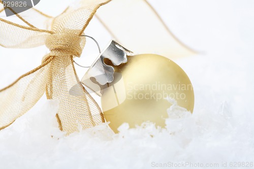 Image of Gold Christmas bauble decoration with ribbon.