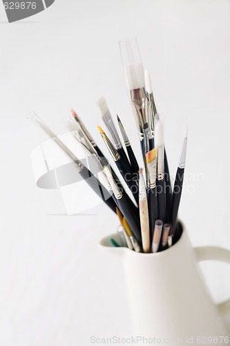 Image of Set of paintbrushes in jug.