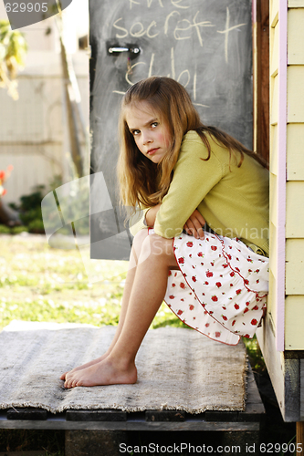 Image of Portrait of a pretty yet grumpy looking young girl.