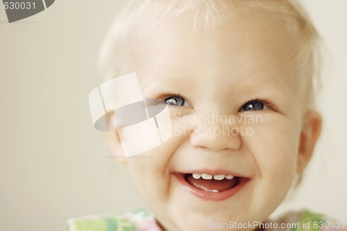 Image of Portrait of a smiling and laughing toddler.