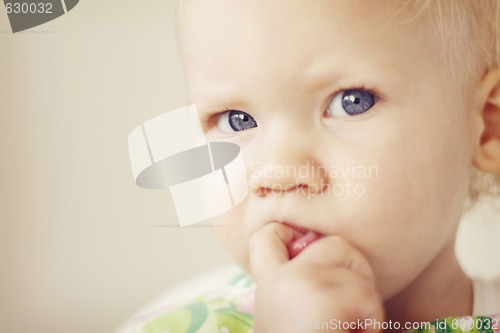 Image of Portrait of a thoughtful looking toddler.