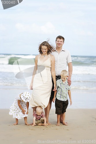 Image of Family enjoying themselves at the beach.