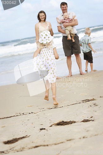 Image of Family enjoying themselves at the beach.