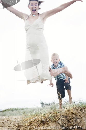 Image of Mother and son having fun at the beach.