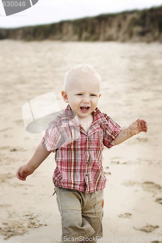 Image of A happy little boy at the beach. 