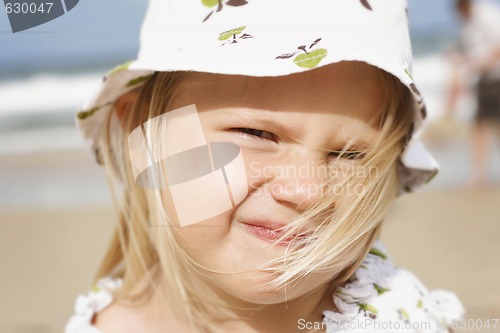 Image of A happy little girl at the beach. 