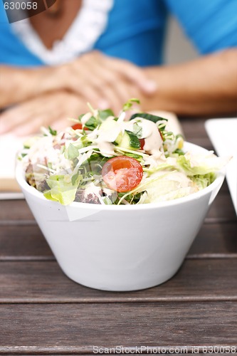 Image of Delicious garden salad in a white bowl.