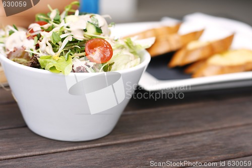 Image of Delicious garden salad in a white bowl.