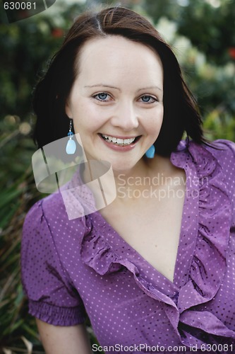 Image of Close-up portrait of a smiling beautiful woman outdoors.
