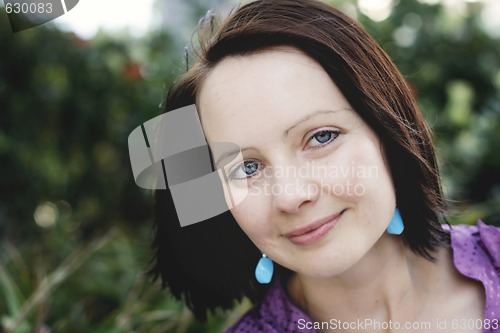 Image of Close-up portrait of a smiling beautiful woman outdoors.