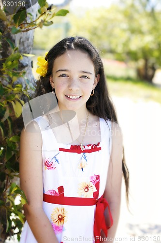 Image of Portrait of a pretty, dark haired young girl outdoors.