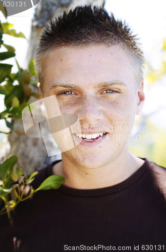 Image of Portrait of a happy young man outdoors.