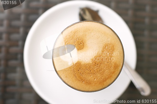 Image of Top down view of a latte in a glass.