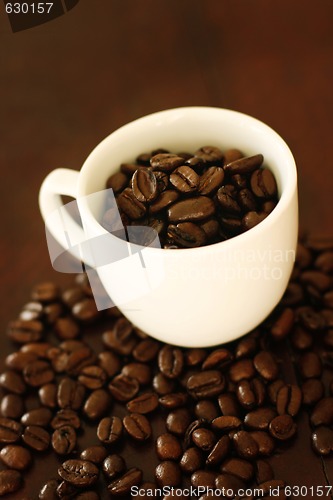 Image of Coffee cup with beans.