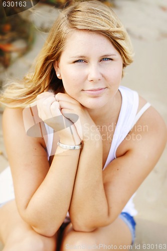 Image of Portrait of a happy beautiful young blonde woman at the beach.