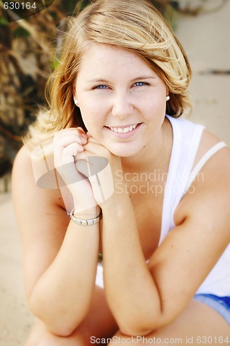 Image of Portrait of a happy beautiful young blonde woman at the beach.