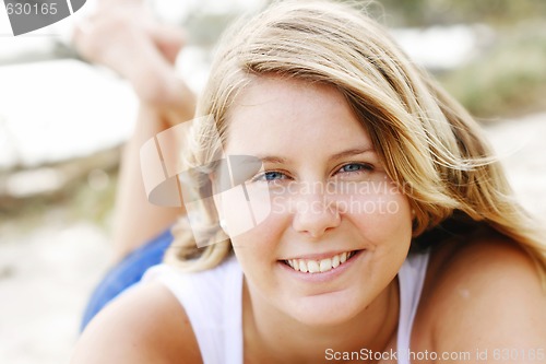 Image of Portrait of a happy beautiful young blonde woman at the beach.