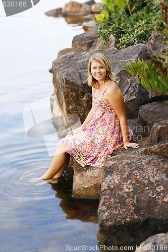 Image of Beautiful young blonde woman at the water’s edge.