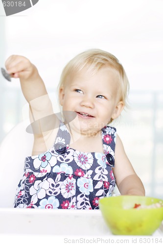 Image of Cute little girl and her breakfast porridge bowl.