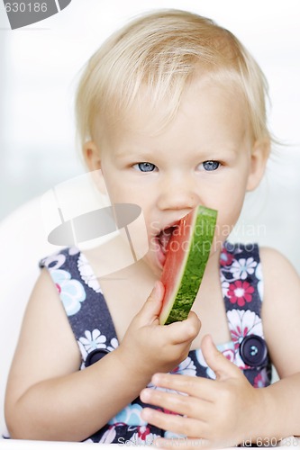 Image of Cute little girl eating a watermelon.