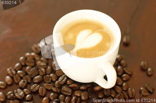 Image of Piccolo latte with a heart shaped coffee art design.