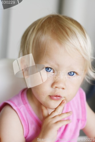 Image of Portrait of a thoughtful looking toddler.