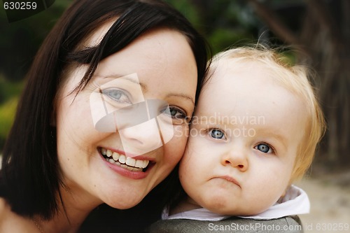 Image of Close-up portrait of a mother and son outdoors.