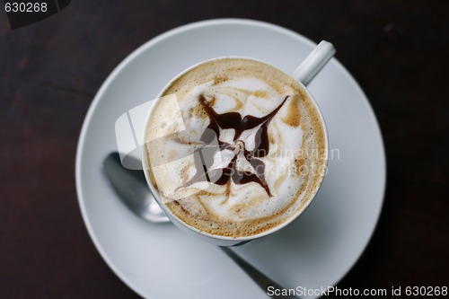 Image of Delicious cappuccino with star design.