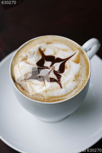 Image of Delicious cappuccino with star design.