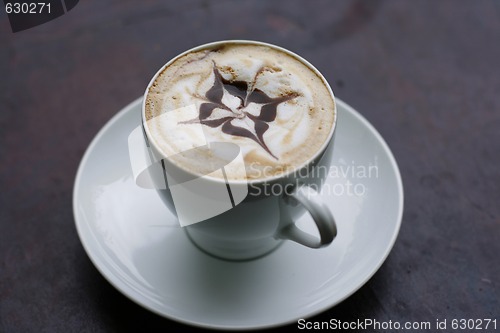 Image of Delicious cappuccino with star design.