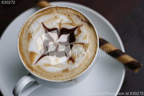 Image of Delicious cappuccino with star design.