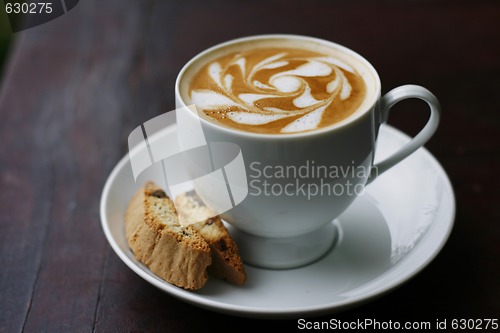 Image of Delicious latte with coffee art swirl design.