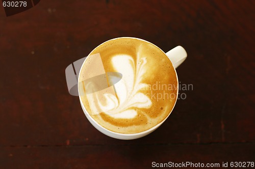 Image of Top view of piccolo latte with a coffee art design.