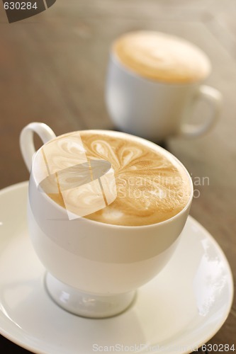 Image of Delicious latte with coffee art design.